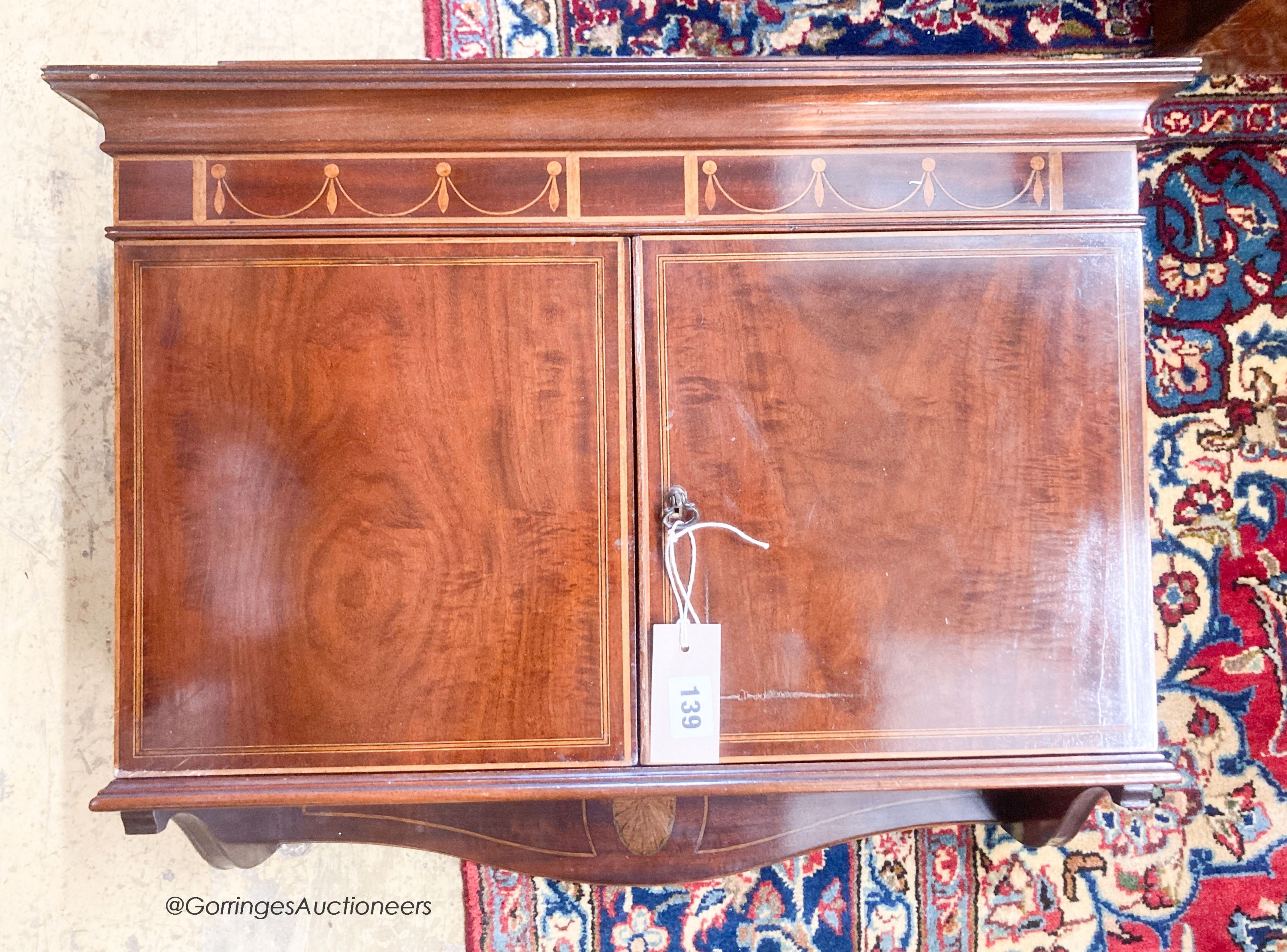 An Edwardian mahogany hanging two door wall cabinet, width 55cm, depth 24cm, height 54cm